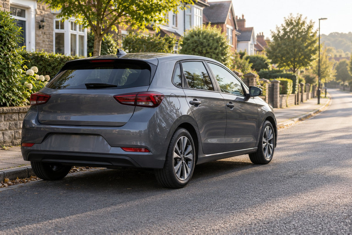 A family hatchback stopped safely at the kerb in morning light after an oil pressure warning appeared